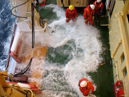 Float coats keep science teams dry as they deploy and recover equipment. Photo by Christine Huffard.