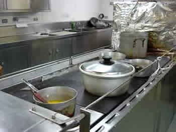 In the galley, railings surround the stove to prevent sliding pots from falling to the floor in rough weather. Photo by Amanda Kahn.
