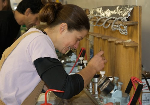 Karie Sines prepares to filter samples from a phytoplankton culture experiment. Photo by Debbie Nail Meyer.