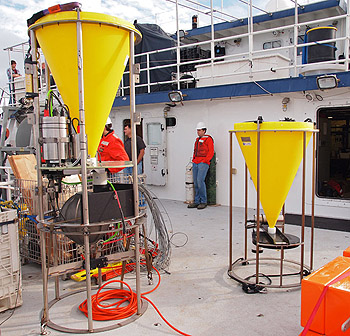 The SES (left) is taller than a standard sediment trap (right) because it uses electronics for photographing slides instead of bottles to capture the sediment deposited into the trap. Photo: Carola Buchner.