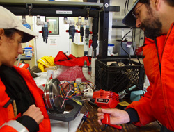 Alana Sherman and Paul McGill check components of the camera tripod to ensure it is ready for deployment tomorrow. Photo: Carola Buchner.