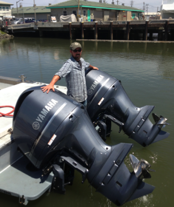 Ocean Observatory Technician Jared Figurski with the new twin 350-horsepower engines on the Paragon.