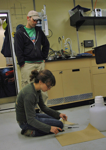 Alicia working on a second design while Chris watches.