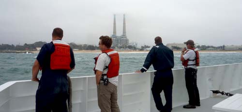 Olin Jordan, Andrew McKee, Jason Jordan, and Perry Shoemake keep watch on the bow as the R/V Western Flyer enters Moss Landing Harbor.