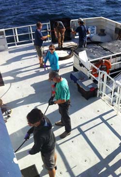 All hands needed on deck to help unwind the damaged (and very oily) tether.