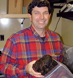 David Clague, MBARI geologist, holding a rock sample from the Pioneer Seamount.