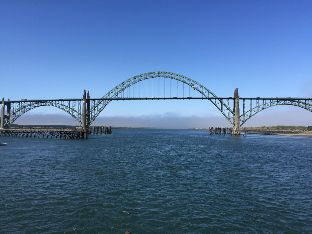 Looking back at the Yaquina Bay Bridge and the fog from the bay.