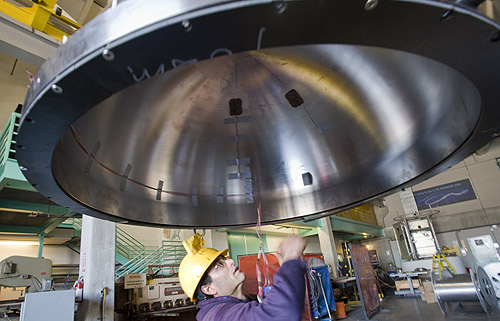 Scott Jensen inspected the upper half of the ESP's titanium pressure housing before it was assembled. The surfaces where the two half-spheres meet must be perfectly clean and smooth to prevent leaks. Image: Todd Walsh © 2009 MBARI