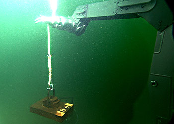 MBARI's remotely operated vehicle Ventana places a small anchor for scientific equipment on the bottom of Monterey Bay. Image: (c) 2000 MBARI
