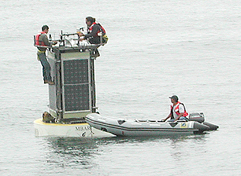 Members of MBARI's Observatory Support Group put the finishing touches on the newly deployed CIMT mooring. Photo Kent Headley (c) 2004 MBARI 