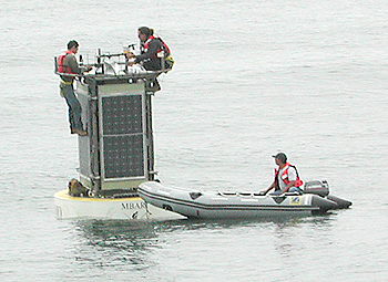 Members of MBARI's Observatory Support Group put the finishing touches on the newly deployed CIMT mooring. Photo Kent Headley (c) 2004 MBARI