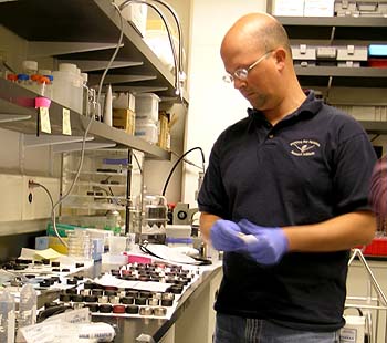 MBARI research technician Joe Jones examines a collection of sample-processing