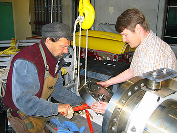  Mechanical engineering technician Larry Bird and marine biologist Jeff Drazen assemble the high-pressure fish trap. Photo: Paul McGill (c) 2004 MBARI