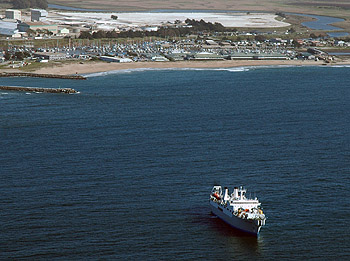 The cable-laying ship Global Sentinel just offshore of Moss Landing, laying the nearshore end of the MARS ocean obseratory cable. MBARI's campus is on the beach just behind the ship. Image: Todd Walsh (c) 2007 MBARI