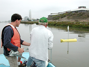 MBARI's Joe Needoba and Steve Fitzwater deploy the new LOBO mooring in a tidal section of the old Salinas River channel. Photo: Ken Johnson (c) 2004 MBARI