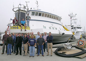 The engineering team for the MOOS science experiment at the Shepard Meander stands in front of the surface buoy before sending it out to sea. This group portrait does not show some of the scientists and ROV pilots who were integral to this ambitious project. Image: Kim Fulton-Bennett (c) 2006 MBARI