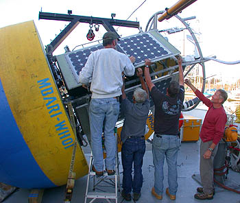 Mooring engineers from Woods Hole Oceanographic Institution make a last-minute inspection of the new MOOS test mooring on board the R/V Point Sur before heading out to sea. Photo: Mark Chaffey