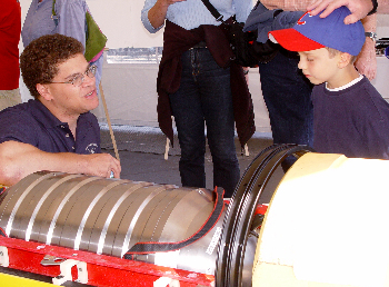 Engineer Hans Thomas discusses AUV design with a young visitor. Photo: Duane Thompson (c) 2004 MBARI