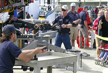 ROV Ventana pilots Mark Talkovic, left, and Knute Brekke, demonstrate the dexterity of the vehicle's robotic arm. Photo: Kim Fulton-Bennett (c) 2004 MBARI