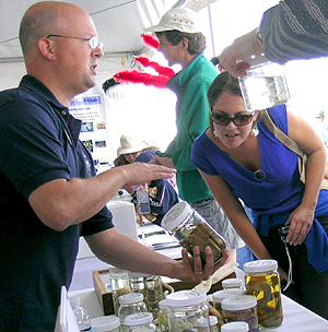 Many visitors to the MBARI open house enjoy looking at the unusual animals that researchers collect from the deep sea, such as these clams being shown by marine biologist Joe Jones. Photo: Heather Fulton-Bennett (c) 2007 MBARI