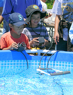 Two boys test out a small remotely operated vehicle that they assembled using PVC pipe and small electric motors. Photo: Heather Fulton-Bennett (c) 2007 MBARI
