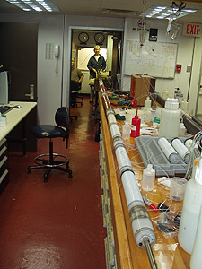 A newly assembled OsmoSampler array awaiting deployment 500 meters below the seafloor. This 7.6-meter-long array contains about 2,500 meters (8,000 feet) of coiled teflon and copper tubing. Before deployment, it will be inserted into a protective metal sleeve, then lowered to the sea bottom and into the borehole through the center of a 10-cm (4-inch) drill pipe. Photo: Hans Jannash (c) 2004 MBARI
