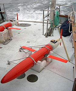 An undersea glider from the Scripps Institution of Oceanography is carried on board a research vessel out to the MB06 study area northwest of Monterey Bay. Image: (c) 2003 MBARI