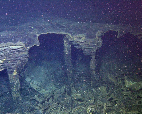 Narrow lava pillars support the thin roof of a drained lobate sheet flow near the fissure for a flow of the 2015 eruption at Axial Seamount.