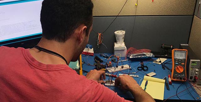 Santos Elizondo working on electronics.