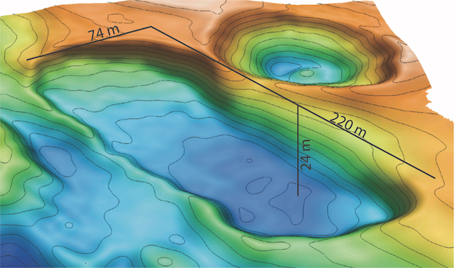 The image is a topographical map of a section of seafloor. The areas of higher elevation are orange, fading to yellow, green, and then blue at greater depths. The image shows a sinkhole that's 220 meters long, 74 meters wide, and 24 meters deep. 
