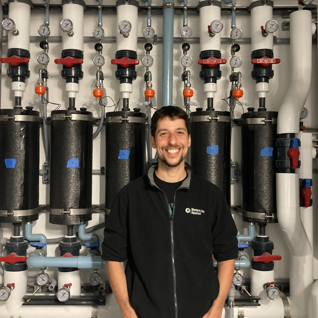 Kyle Harrigan in front of some of the water treatment pipes at MBA