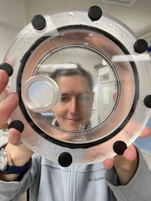 Natalia Llopis Monferrer holding up a roller tank containing a phaeodarian colony.