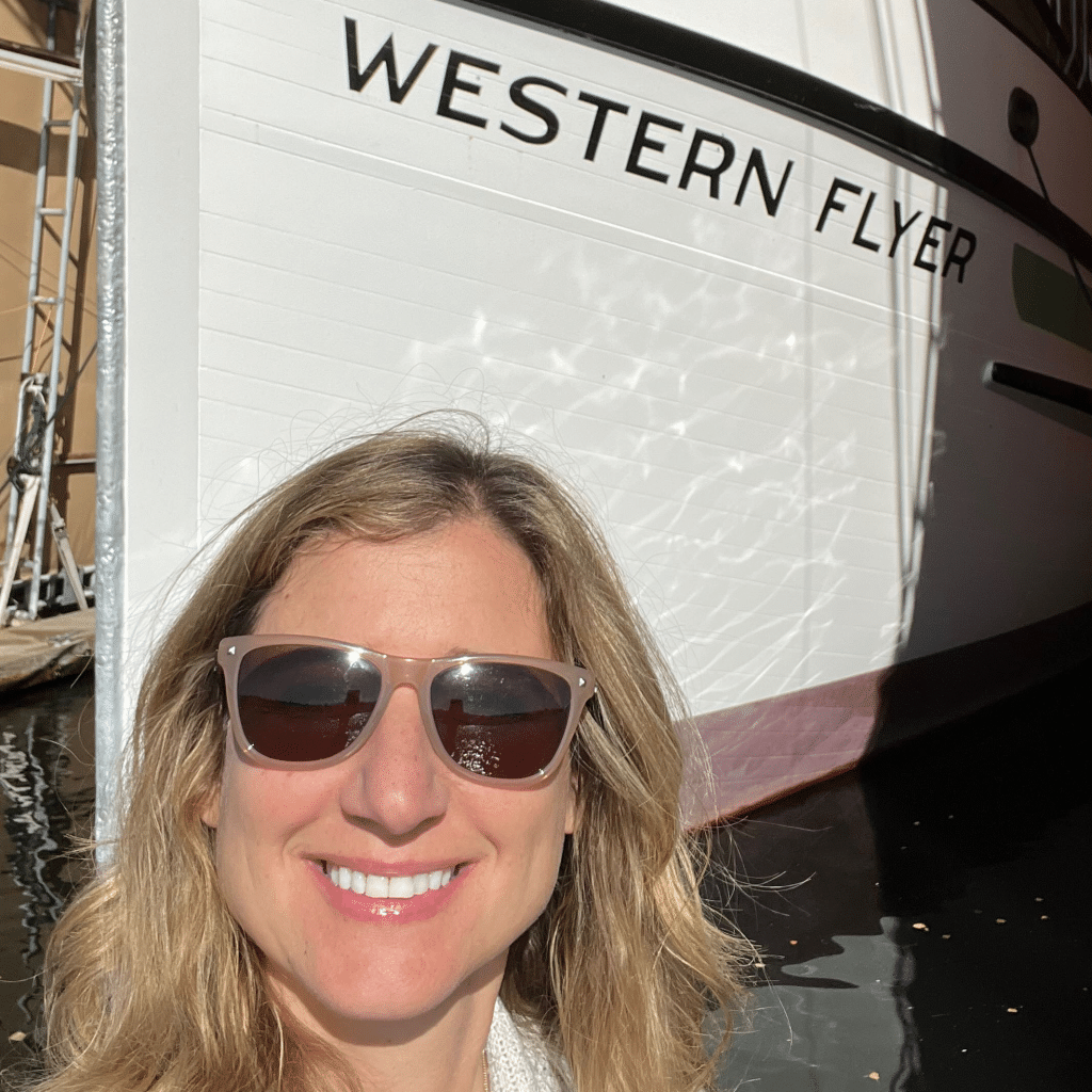 Photo of Sherry Flumerfelt in front of the RV Western Flyer